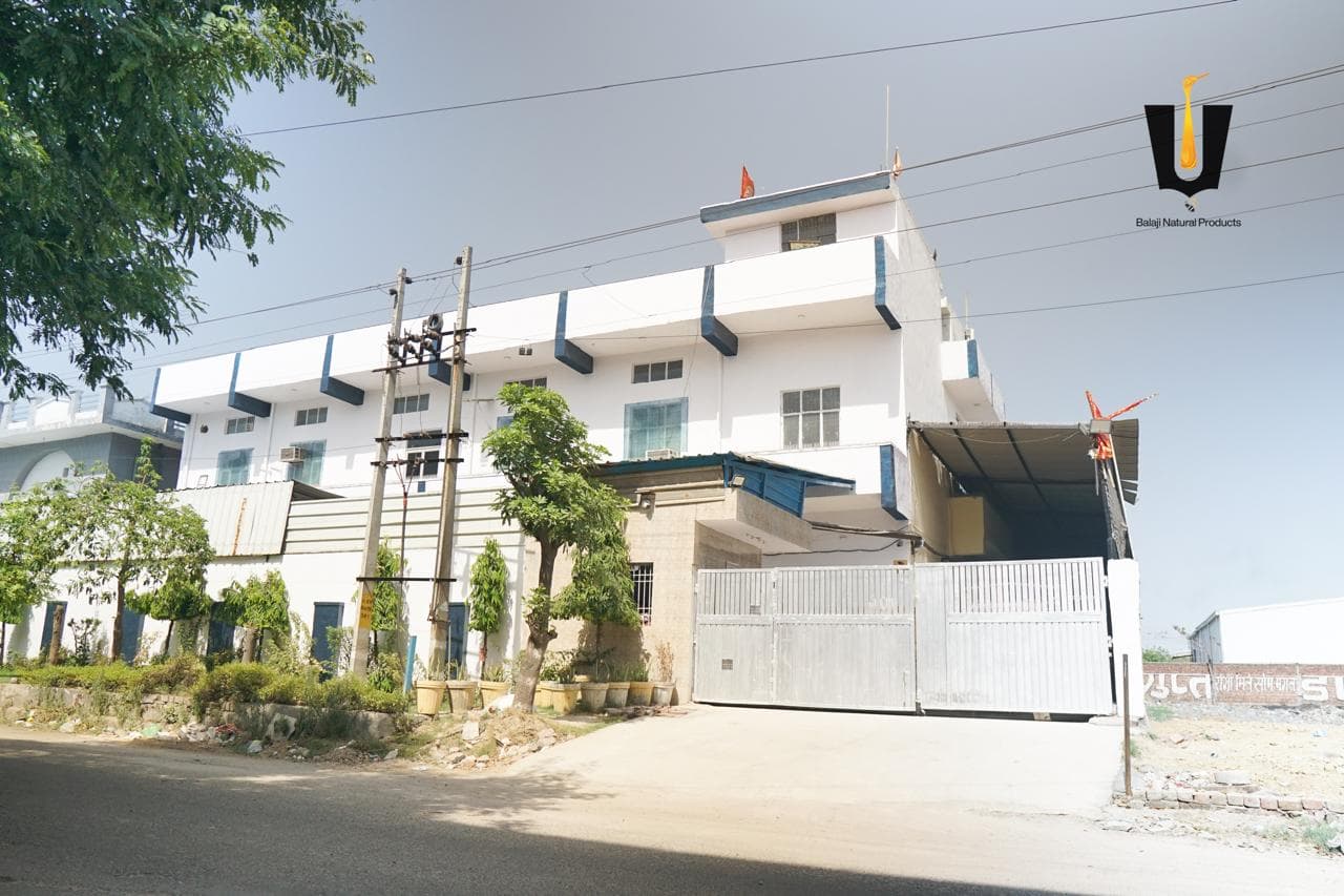 Exterior of the Balaji Natural Products honey manufacturing facility behind the main gate in Sonipat, Haryana